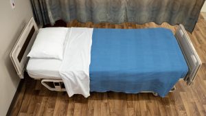 A closed bed made without wrinkles, and with the sheet flipped down from the pillow.